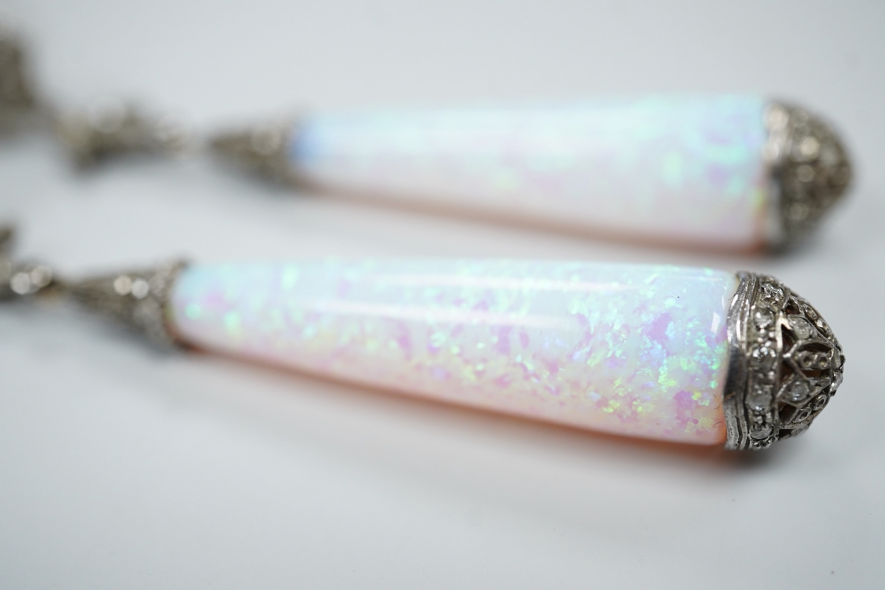 A pair of 1920's style white metal, synthetic opal and diamond chip set drop earrings, 63mm, gross weight 8.2 grams.